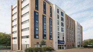A Travelodge hotel with a modern design, featuring multiple floors and a brick facade.