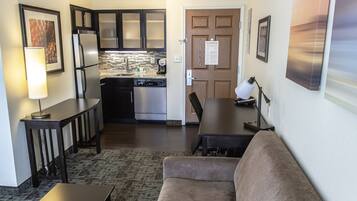 A compact living space with a kitchenette, a dining area, and a seating area.