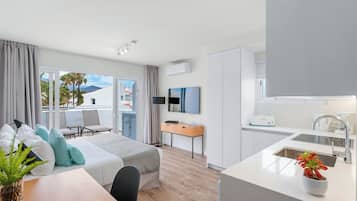 Studio | 2 bedrooms, in-room safe, laptop workspace, iron/ironing board