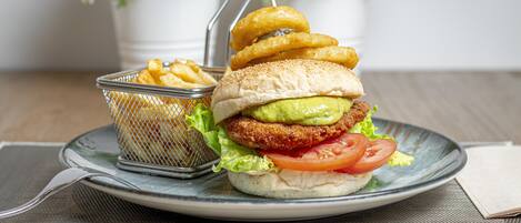 A plate with a burger, fries, and onion rings.