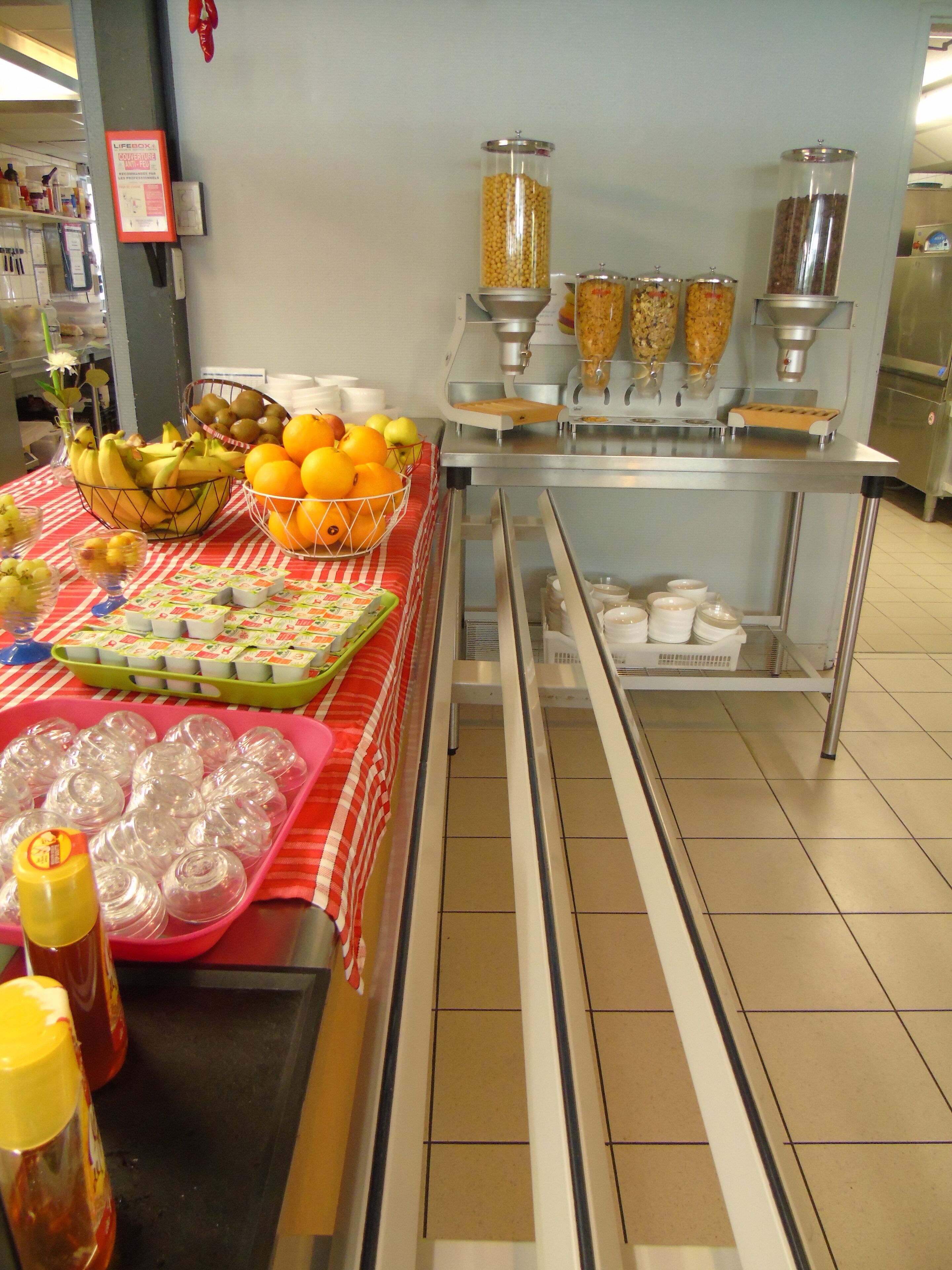 A buffet setup with various food items and condiments.