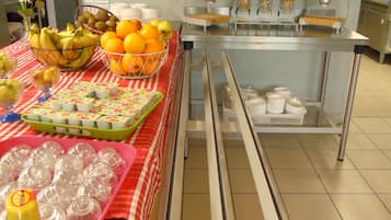 A buffet setup with various food items and condiments.