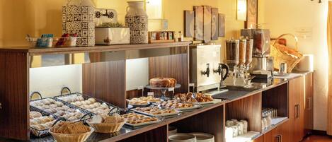 A buffet with various food items and a coffee station.