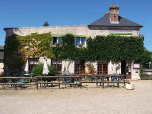 A building with a restaurant, hotel, and 1/2 pension sign. - Auberge Saint Martin (Surville)