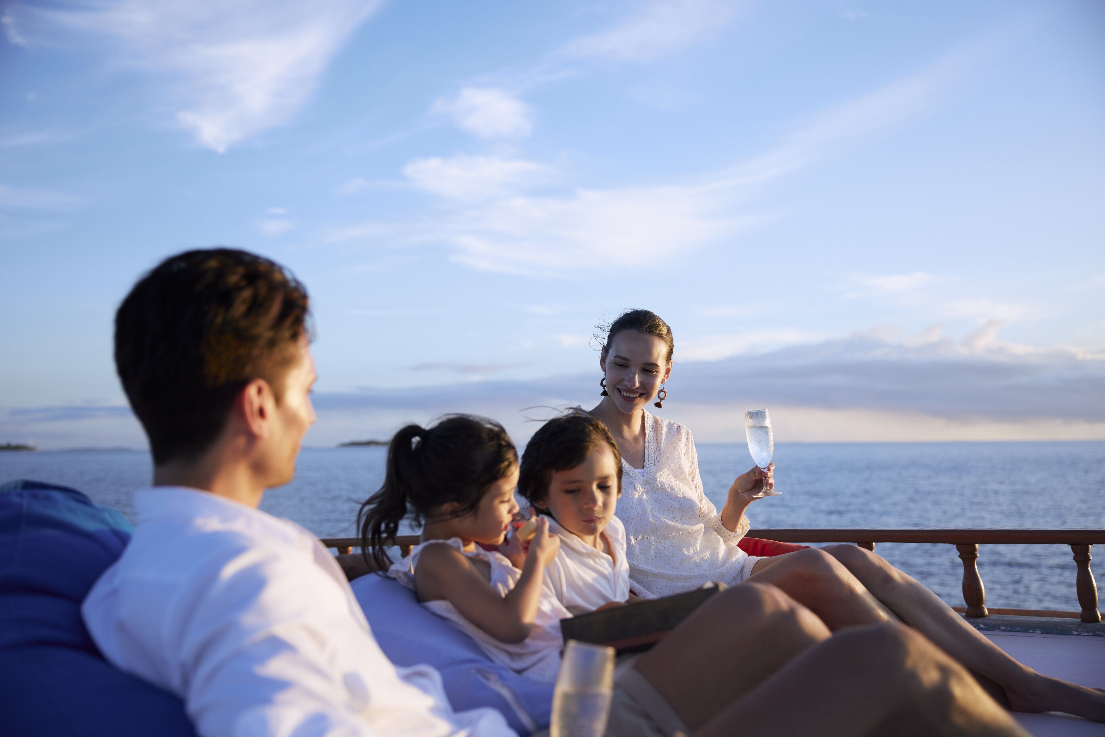 A group of people on a boat with a view of the sea.