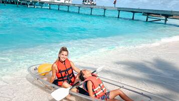 Relax on the pristine beach with a tranquil pier and clear waters, perfect for leisurely water activities.