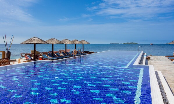 2 outdoor pools, open 8:00 AM to 7:00 PM, pool umbrellas, pool loungers