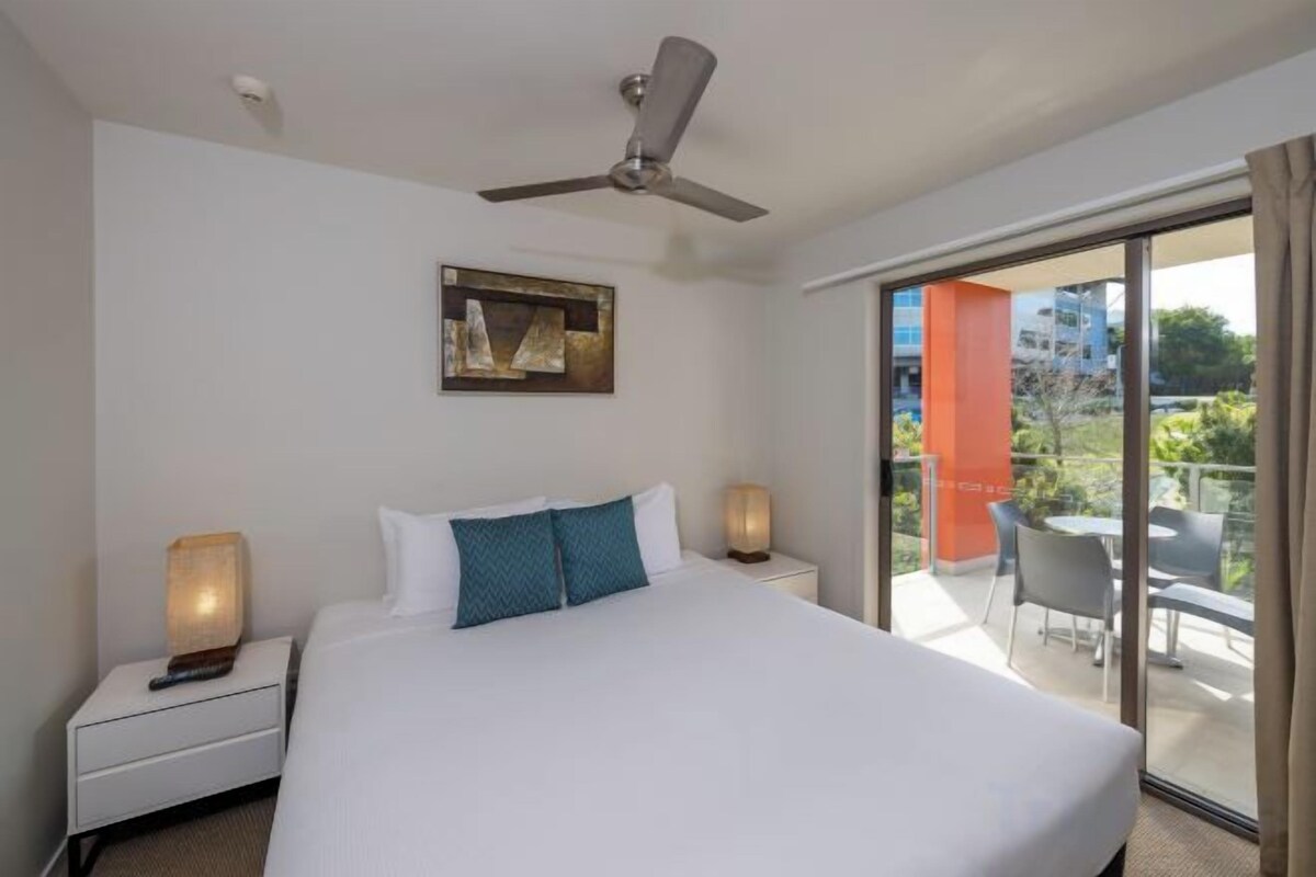 Premium bedding, desk, laptop workspace, blackout drapes