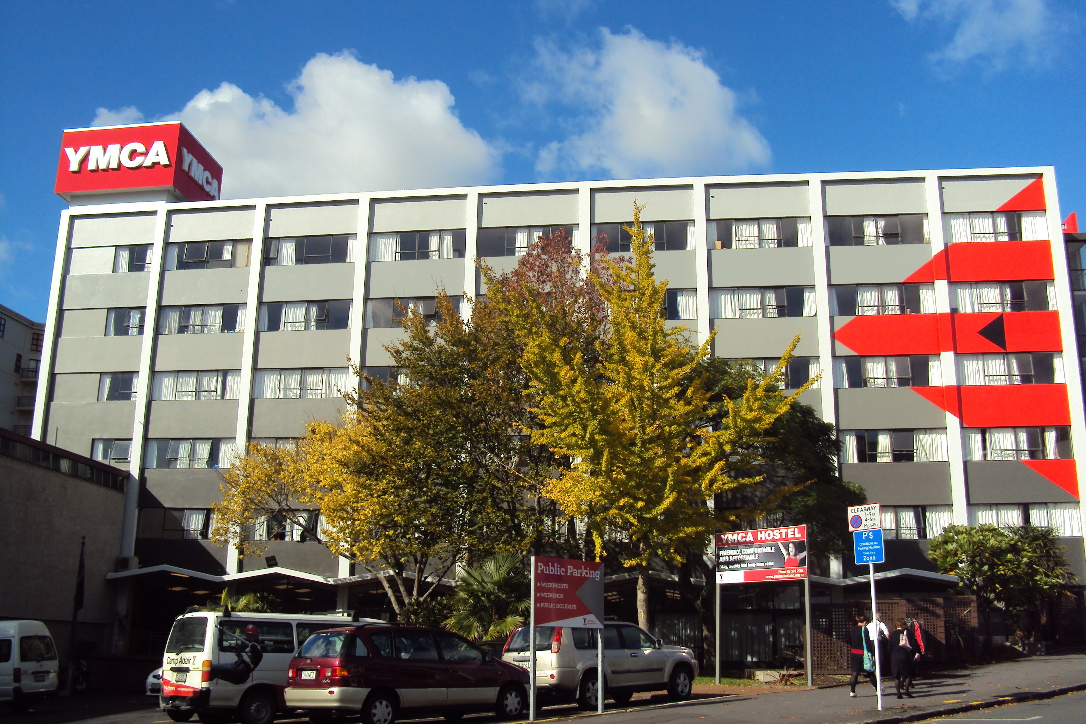 A multi-story building with a prominent red and white sign reading "YMCA".