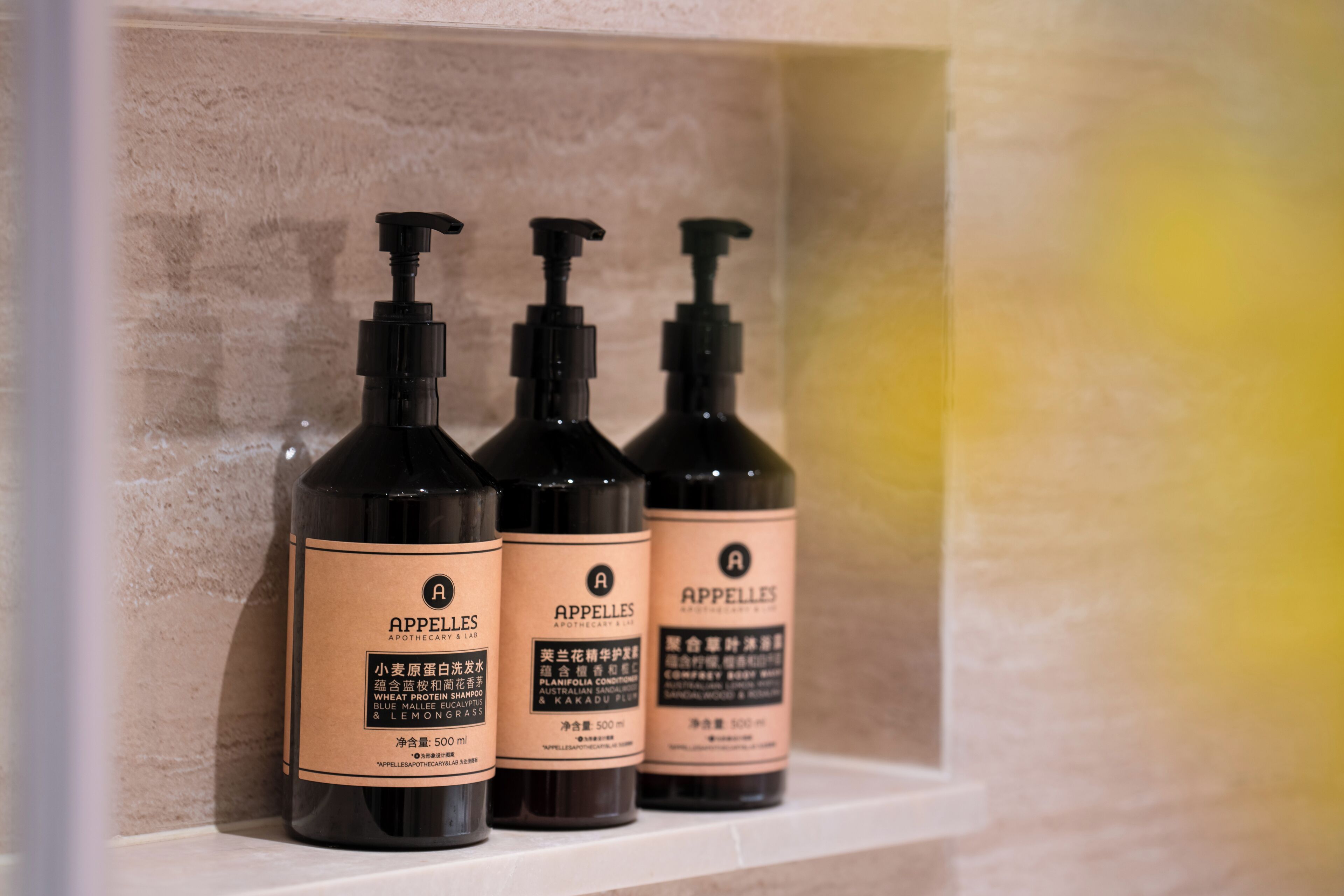 Three bottles of APPELLES APOTHECARY & LAB products on a shelf.