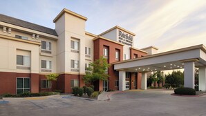 A hotel with a modern facade, a covered entrance, and a parking lot. - Fairfield Inn & Suites Visalia Tulare (Tulare)