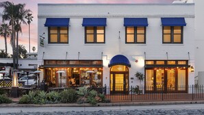 A white building with blue awnings and a number '121' sign. - Riviera Beach House (Santa Barbara)