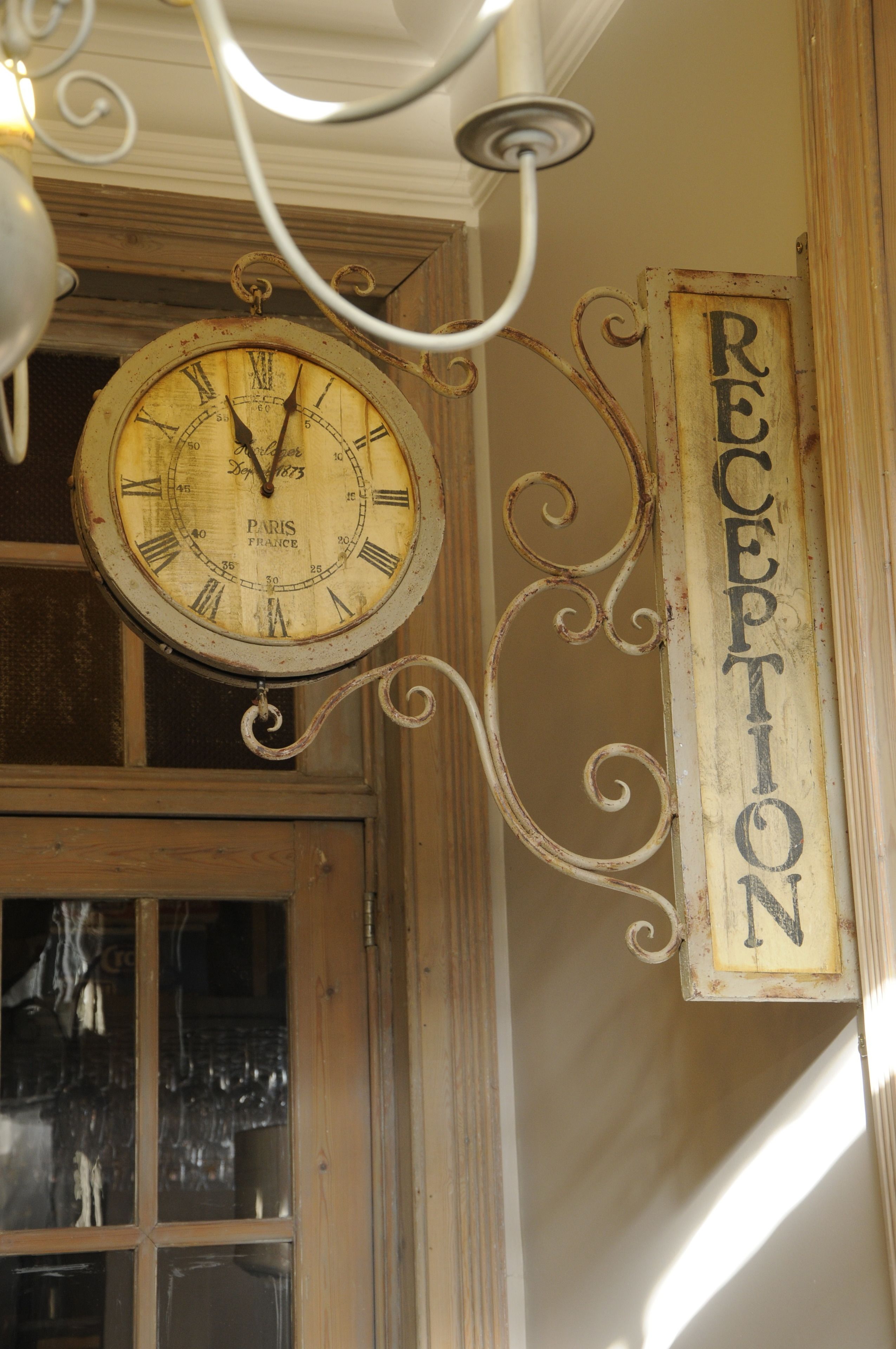 A vintage Paris clock with a "RECEPTION" sign.