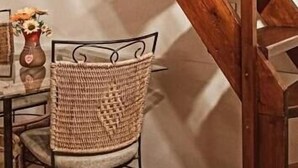 A wooden staircase with a chair and a table in the foreground. - Hotel La Palma (Catania)