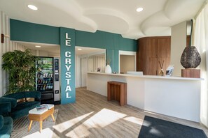 A modern reception area with a vending machine, a seating area, and a reception desk.