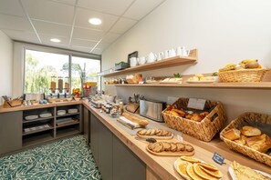 A breakfast buffet with various food items and utensils. - Best Western Hotel Le Crystal Dinard (Dinard)