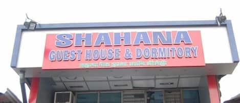 A sign for a guest house and dormitory named "Shahana".