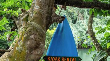 Señal azul de alquiler de kayaks con información de contacto.