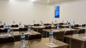 A conference room with tables, chairs, water bottles, and glasses. - Amaris Hotel Thamrin City - Jakarta (Jakarta)