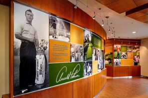 A golf-themed display with memorabilia and text panels. - SpringHill Suites Pittsburgh Latrobe (Latrobe)