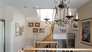 A staircase with wooden handrails and metal balusters, leading to an upper floor. - Birch House B&B (Weymouth)