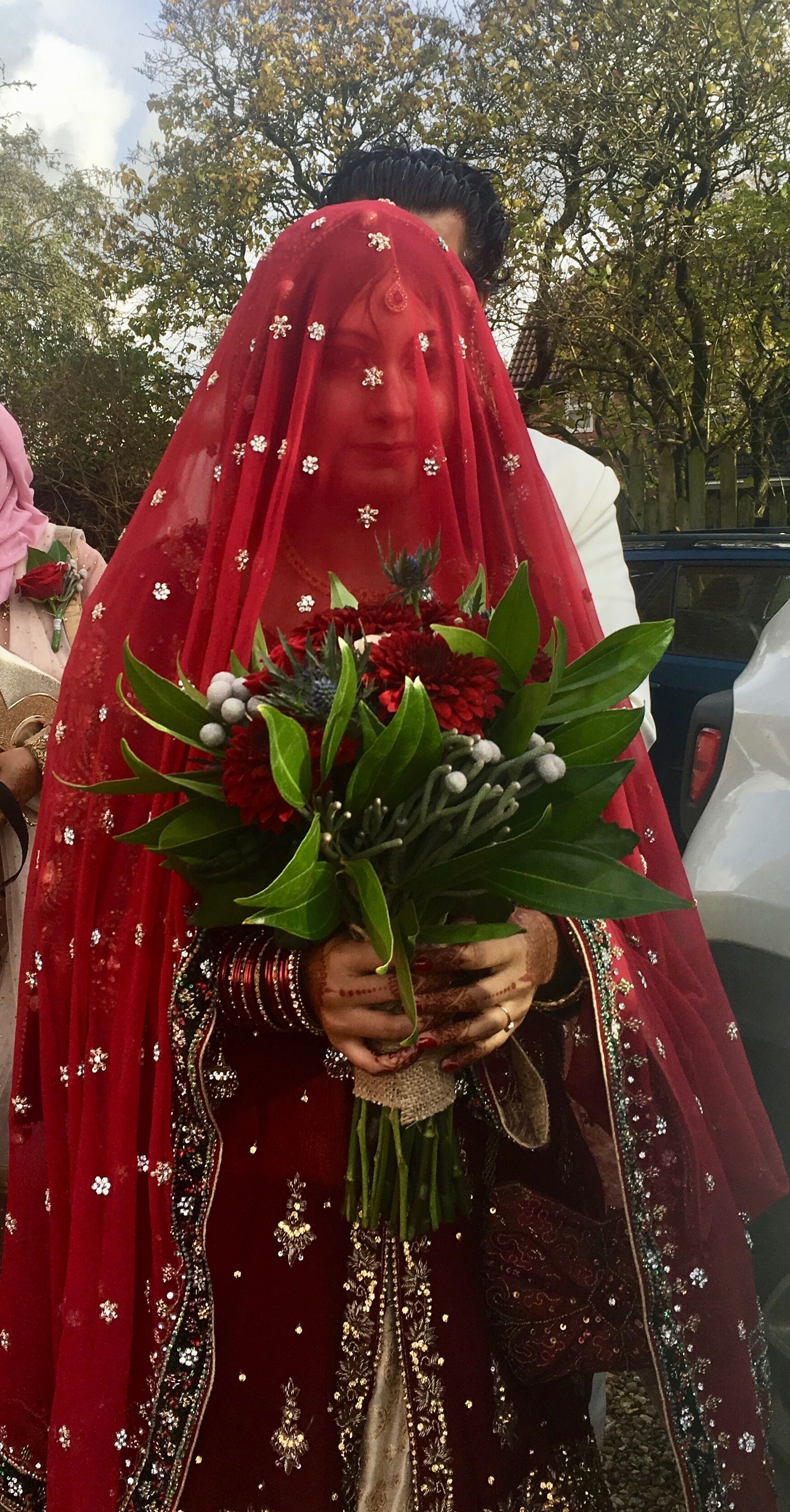 A person holding a bouquet of flowers.