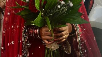 A person holding a bouquet of flowers.