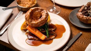A plate of Yorkshire pudding, carrots, and a gravy. - The Cherry Tree Rochford (Rochford)