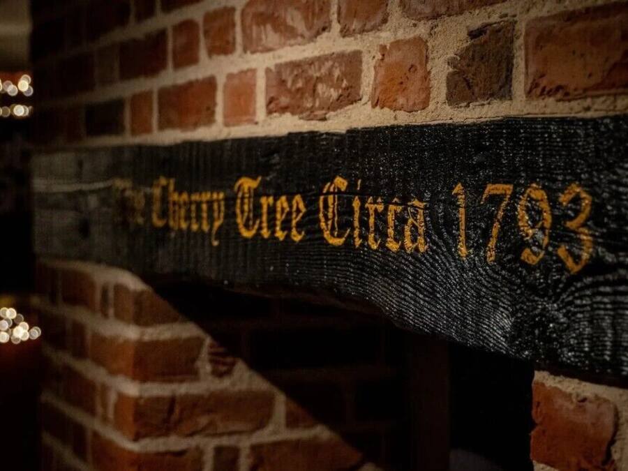 A brick wall with a sign that reads 'Cherry Tree Circle 1793'.
