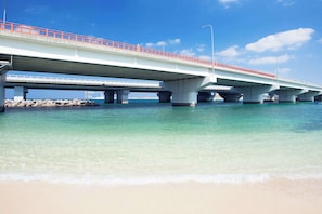 Spanning the coastline, this bridge offers breathtaking views of the ocean and sandy beach below.