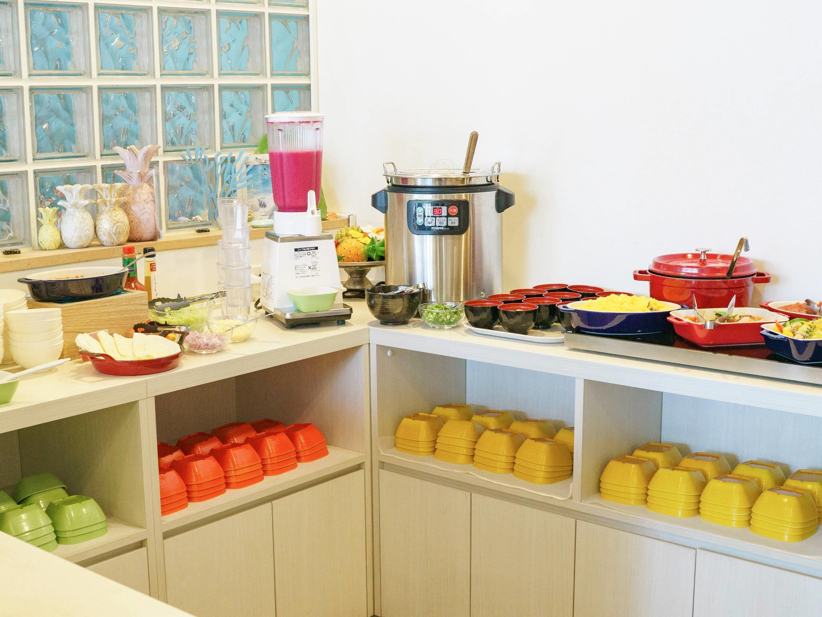 A buffet setup with various food items and serving utensils.