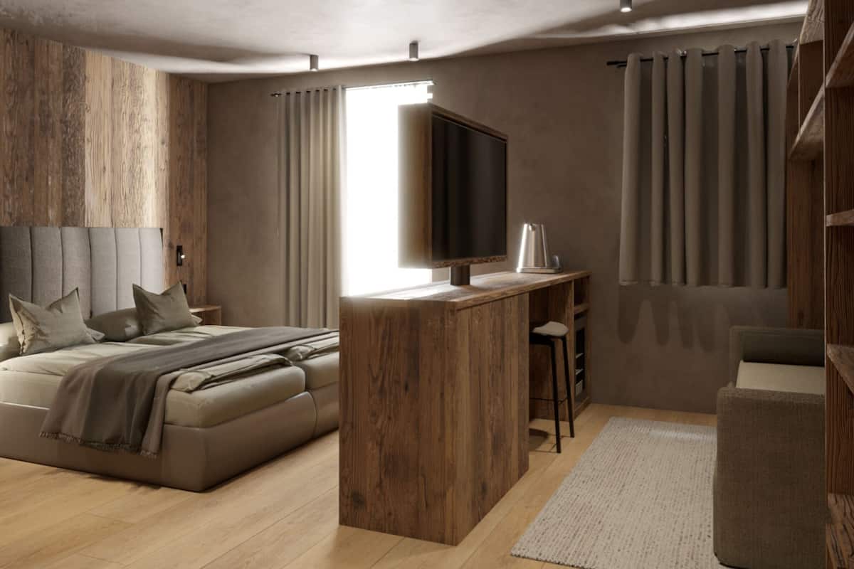 Un dormitorio moderno con cama, escritorio y televisor.