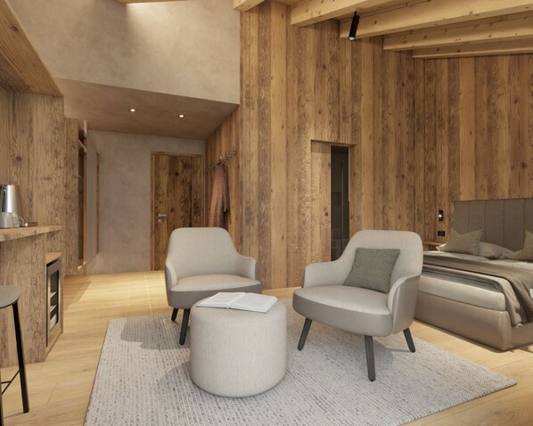 A modern bedroom with a wooden wall, a bed, two armchairs, a coffee table, and a bookshelf. - Al Nin Hotel&Spa (Livigno)