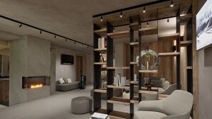 A modern living room with a fireplace, a sectional sofa, a coffee table, and a wooden bookshelf. - Al Nin Hotel&Spa (Livigno)