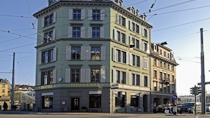 A multi-story building with a sign for "Hotel Helvetia" and "El Restaurante Helvetia" on the ground floor. - Boutique & Art Hotel Helvetia (Zürich)