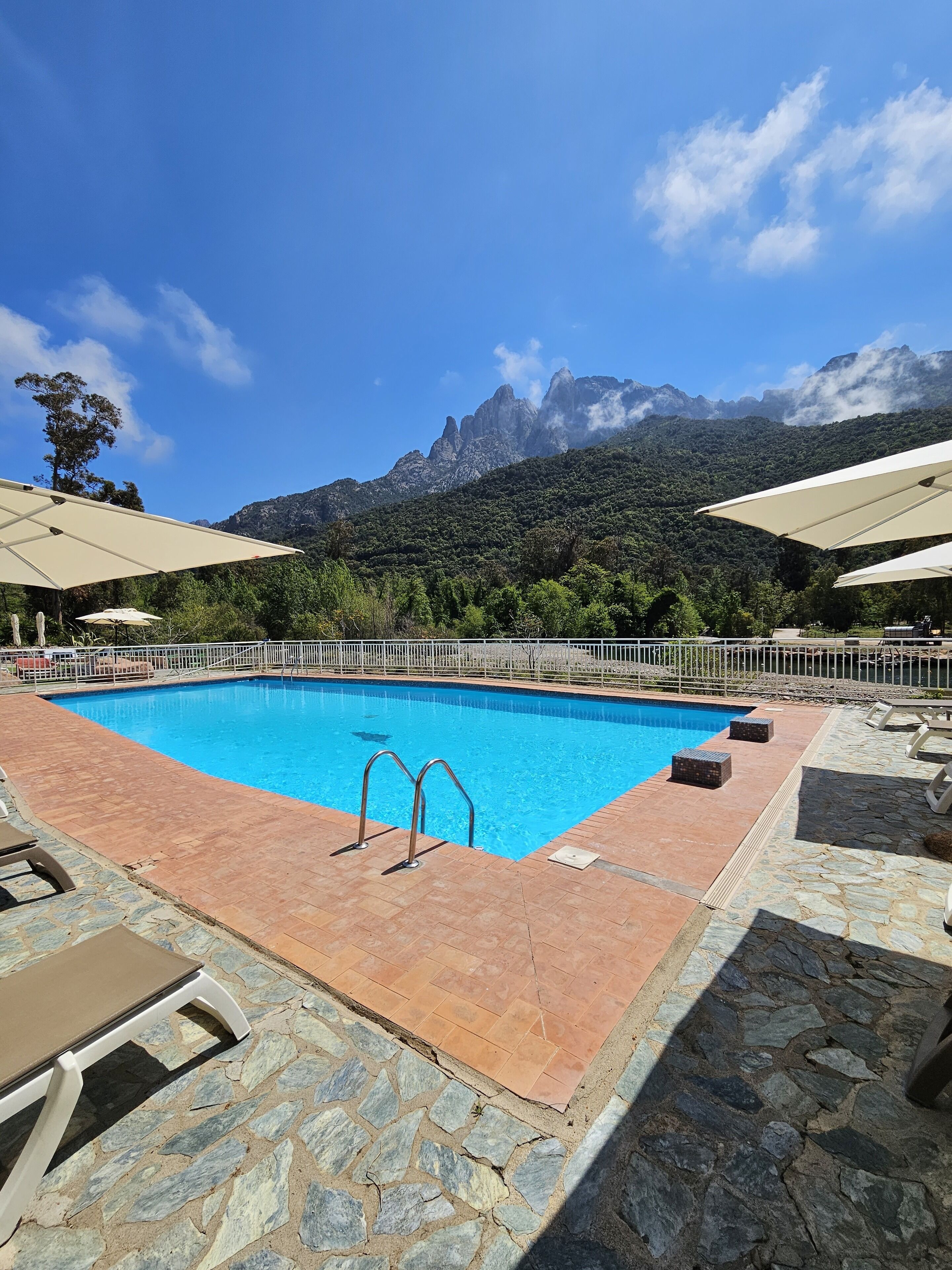 outdoor pool, open 9:00 am to 8:00 pm, pool umbrellas, pool loungers