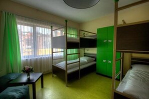 A bunk bed room with a window, a desk, and green lockers. - 2A Hostel (Berlin)