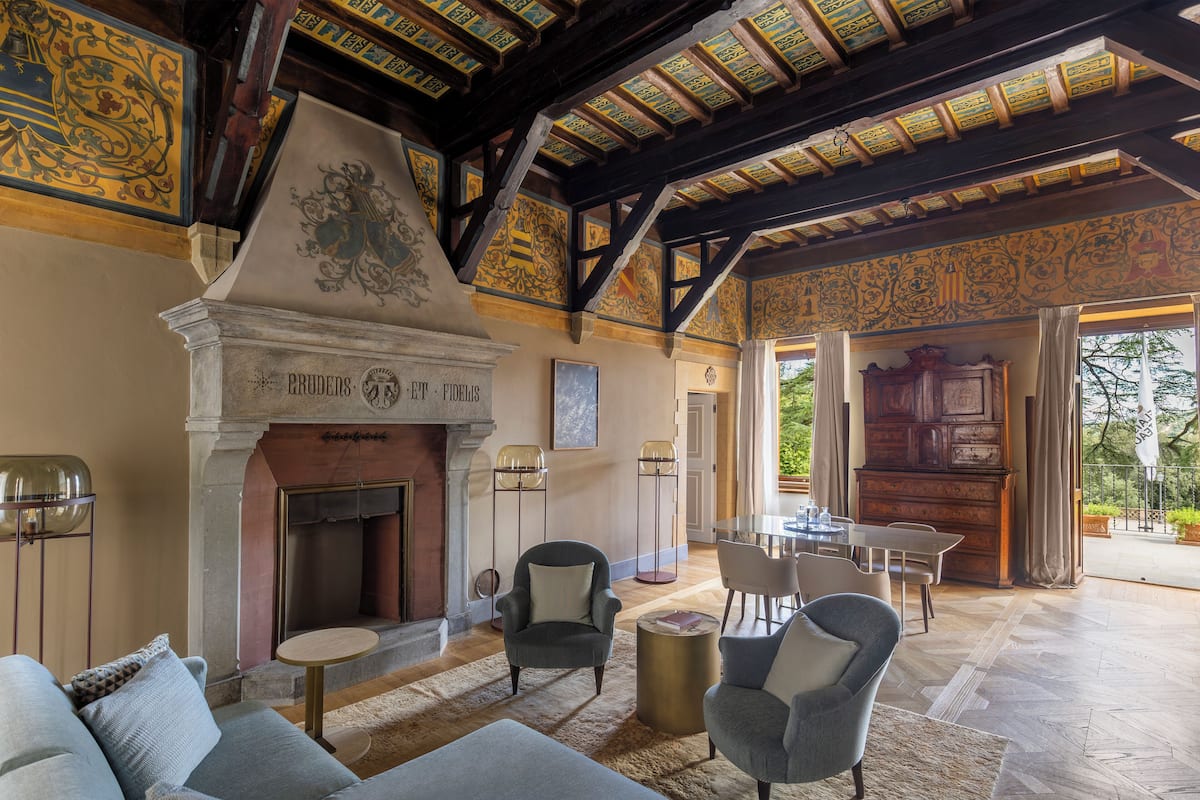 A spacious living area with a fireplace, comfortable seating, and a view of the outdoors.