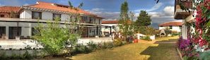 A residential area with houses featuring red-tiled roofs and white walls.