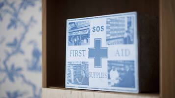 A first aid box with a cross symbol and text indicating it contains first aid supplies.