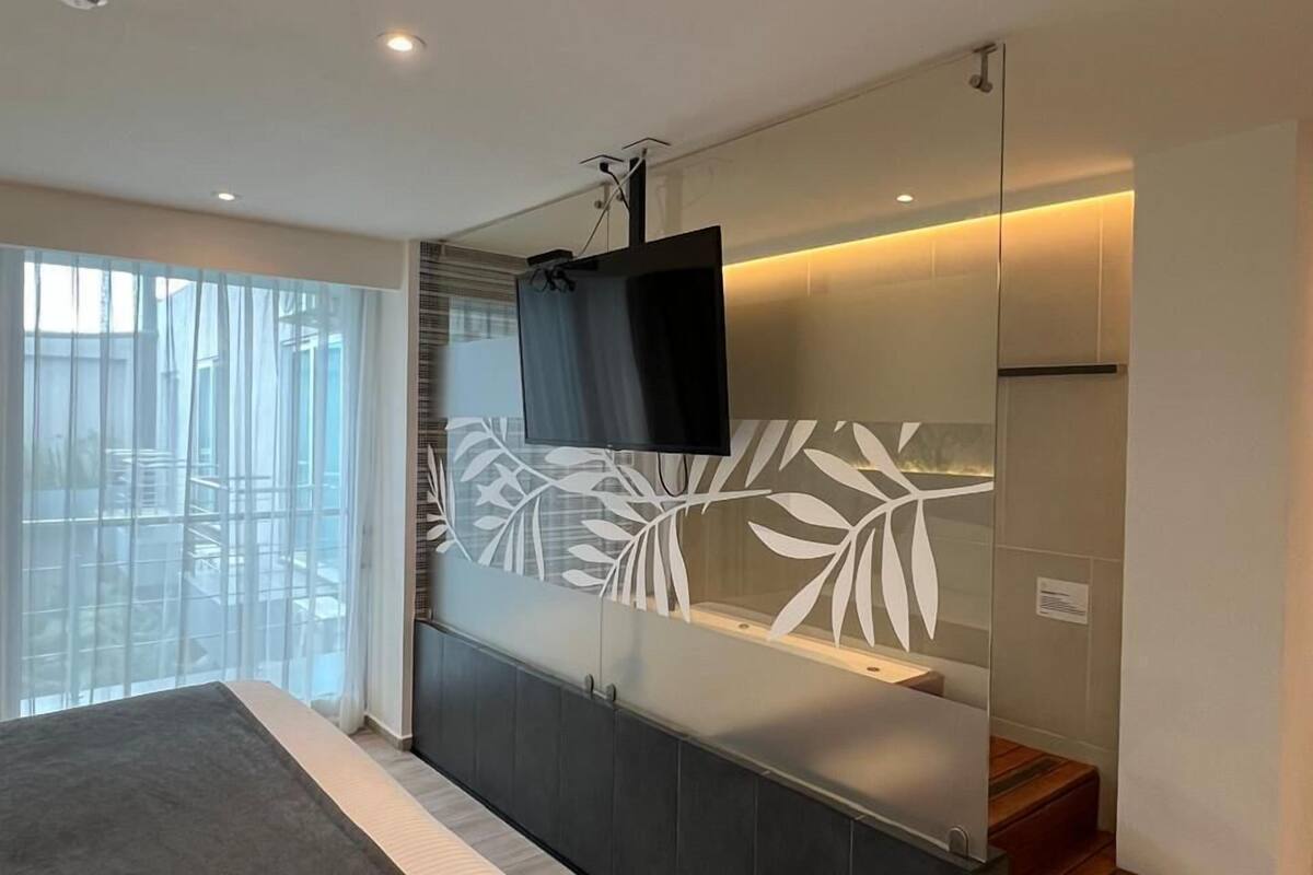 deluxe room | living area | 32-inch lcd tv with cable channels, tv, video game console