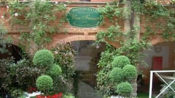 A brick archway with a sign for 'Restaurant Uma Francesca' above it.