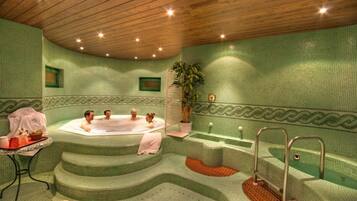 Relax in a spacious spa area with a curved jacuzzi and multiple seating areas, perfect for socializing.