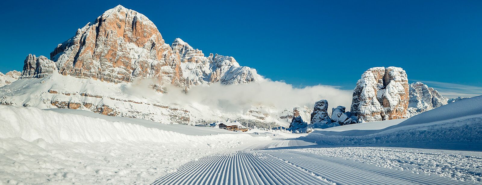 A snow-covered mountain landscape with a clear sky.