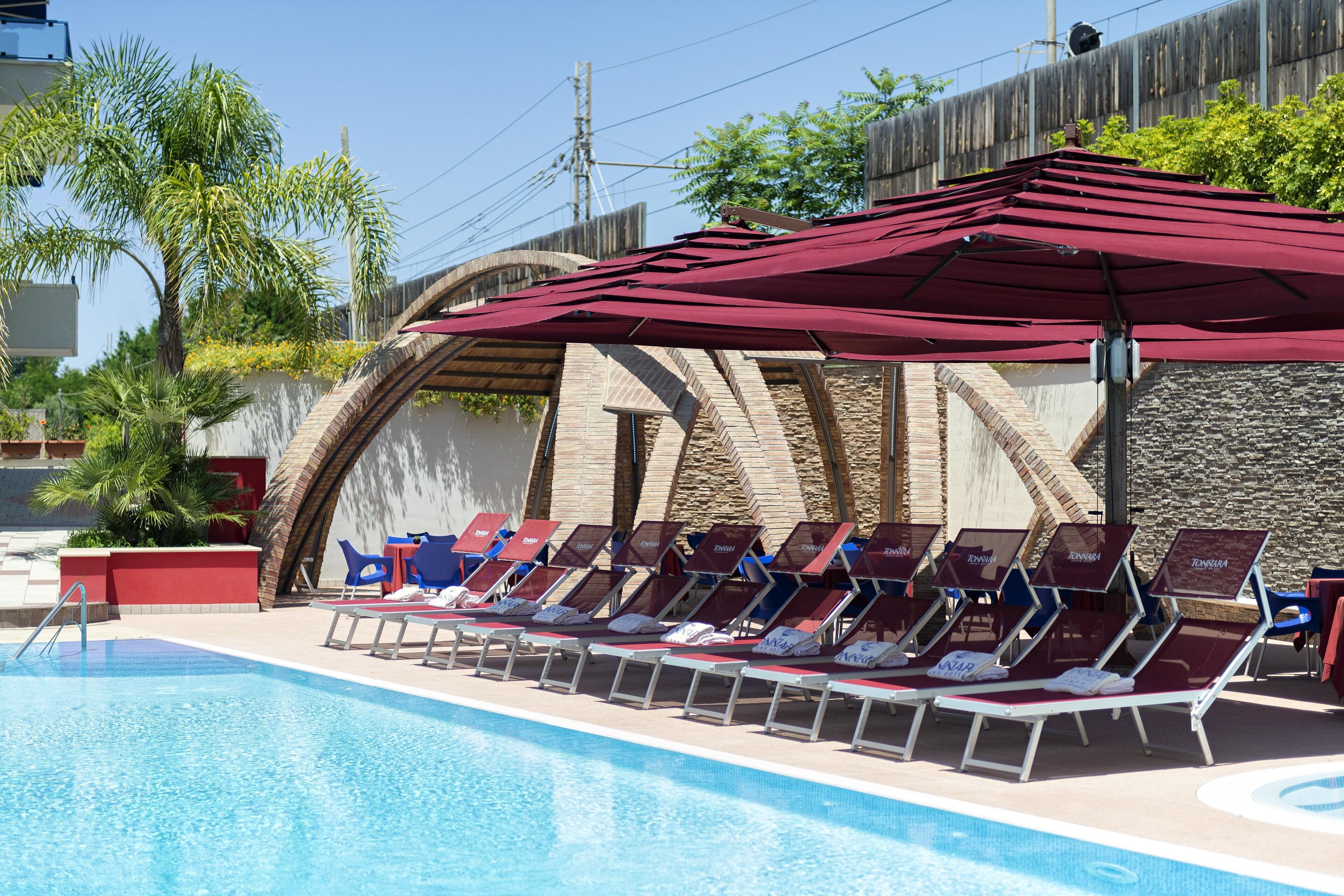 Seasonal outdoor pool, open 10:00 AM to 7:00 PM, pool umbrellas