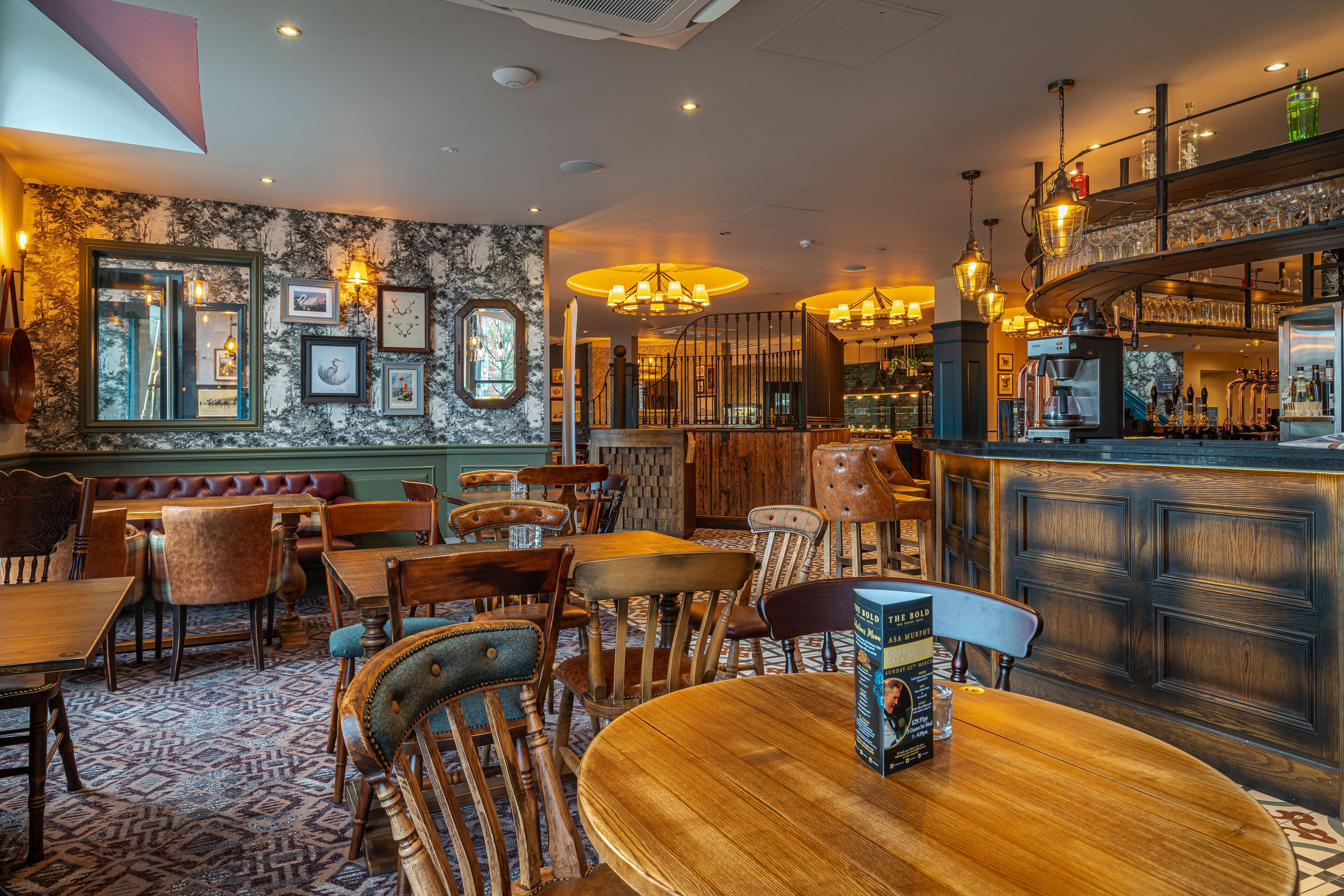 A restaurant with wooden furniture, a bar area, and a patterned carpet.