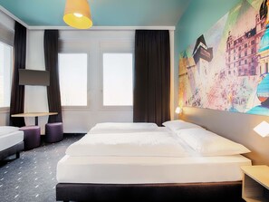 A hotel room with a bed, two bedside tables, a desk, and a large window. - B&B Hotel Graz-Hbf (Graz)