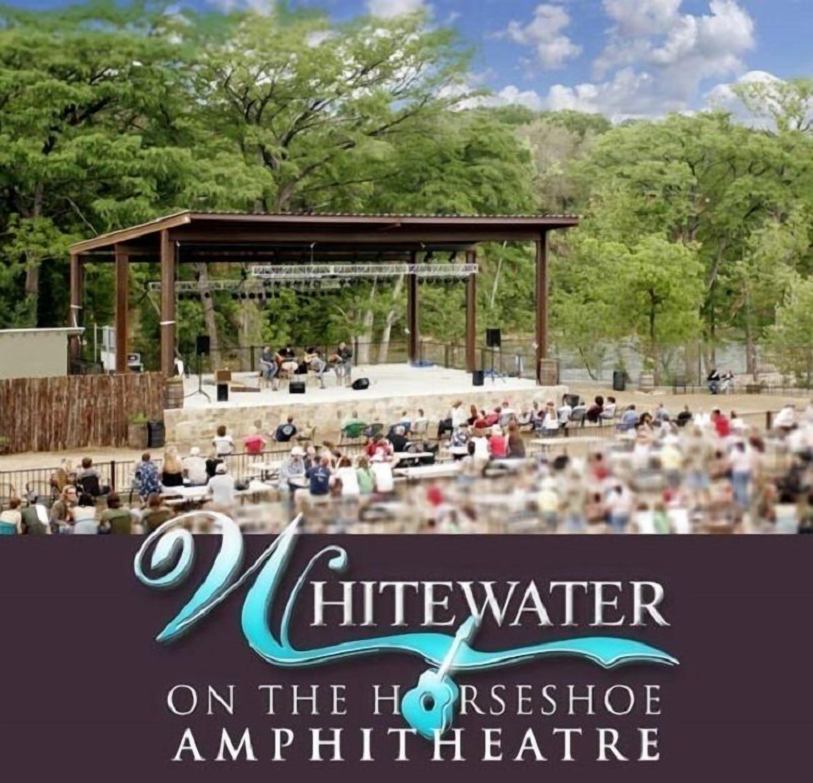 A horseshoe amphitheater with a stage and audience seating.