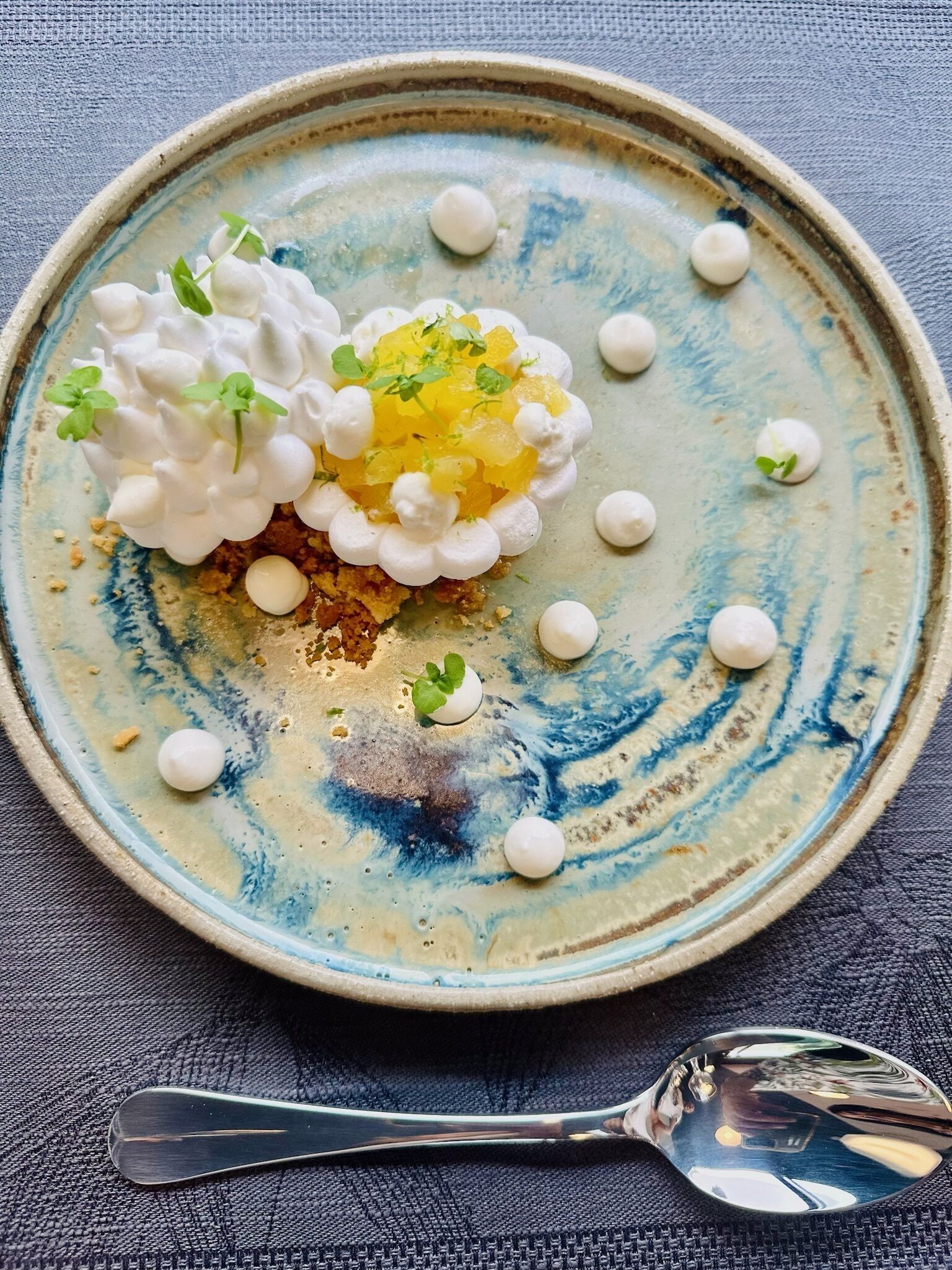 A plate with a dessert on a textured blue and white ceramic plate.