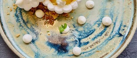 A plate with a dessert on a textured blue and white ceramic plate.
